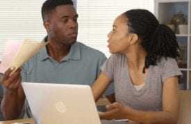 Frustrated Young Black Couple Arguing Over Finances And Bills